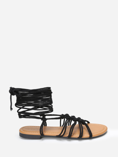 Sandales plates noires à fins lacets tressés