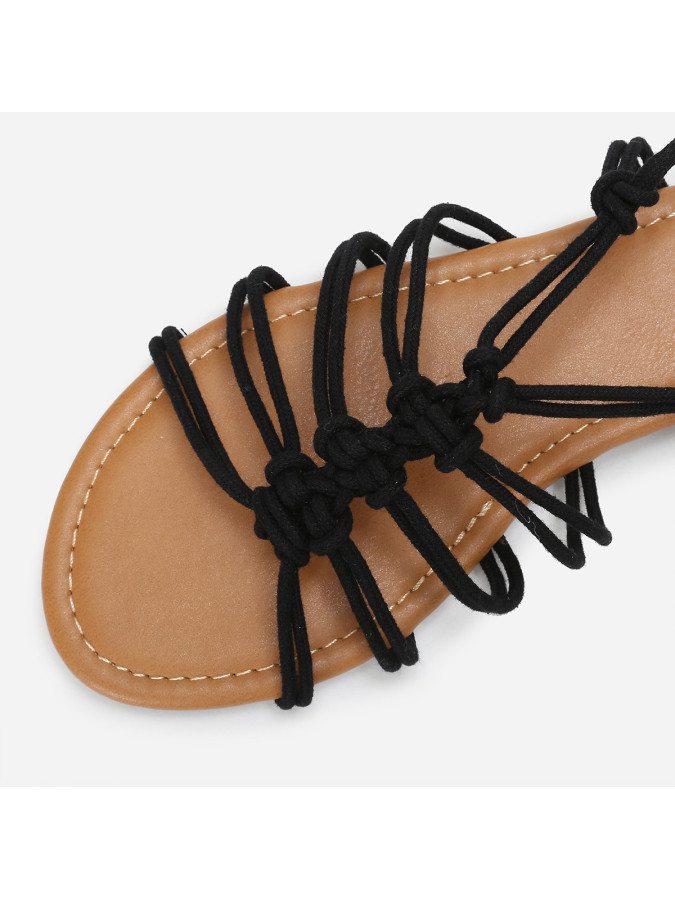 Sandales plates noires à fins lacets tressés