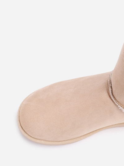 Boots fourrées en suédine à rubans