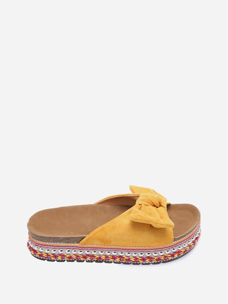 Mules jaunes à noeud et semelle à motifs