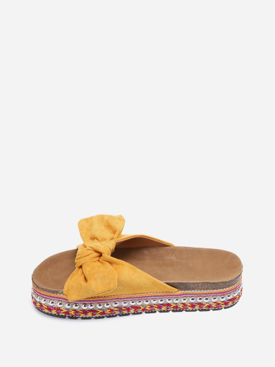 Mules jaunes à noeud et semelle à motifs