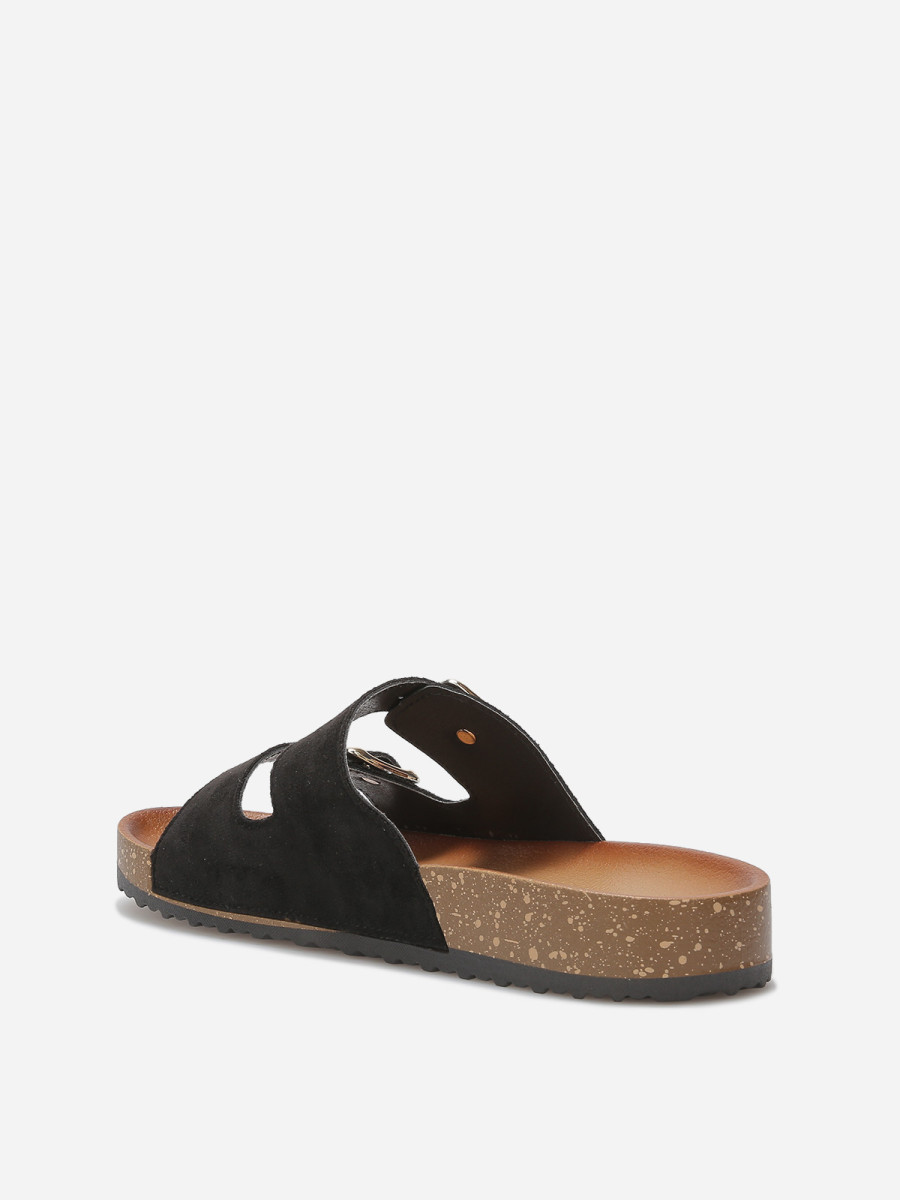 Mules plates noires en suédine façon mocassin petit nœud à détail doré