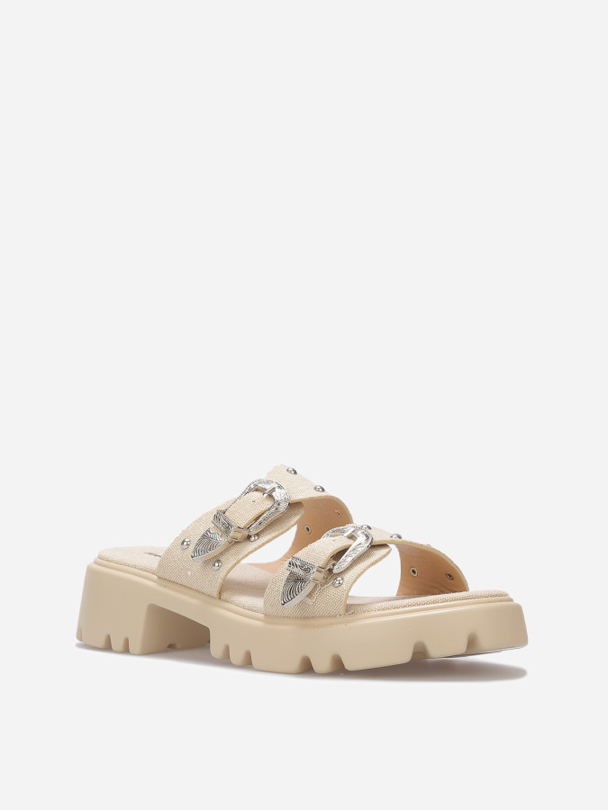 Mules à boucles et clous argentés