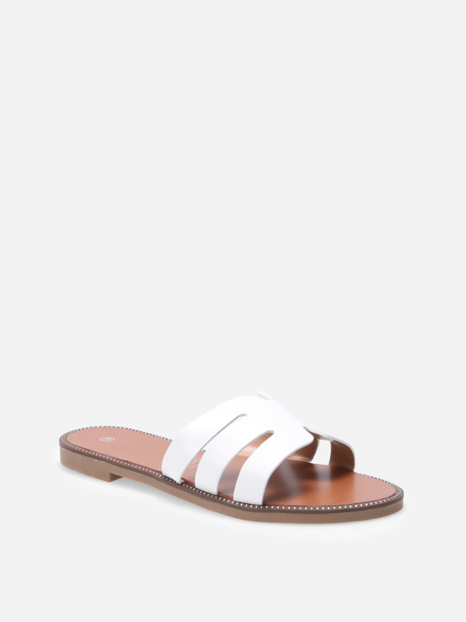 Mules plates à bride ajourée et clous