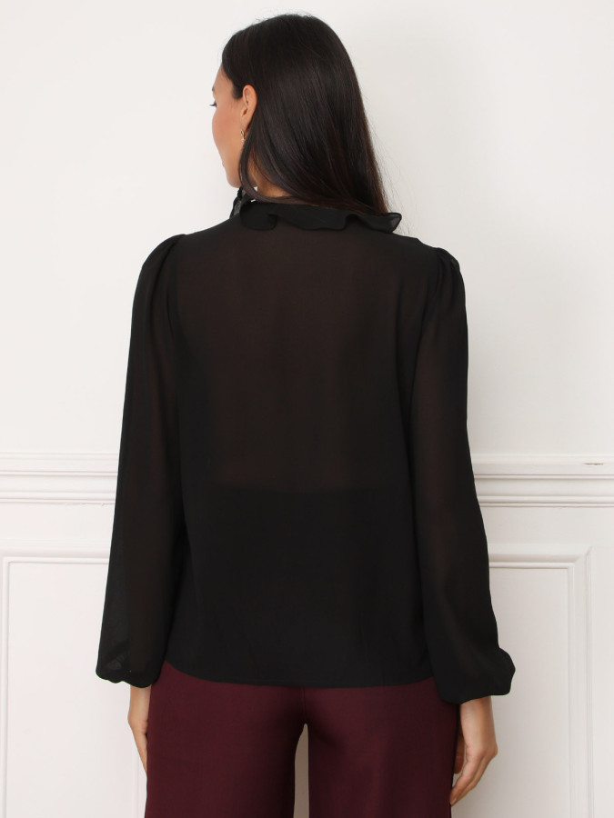 Blouse noire à volants et manches bouffantes