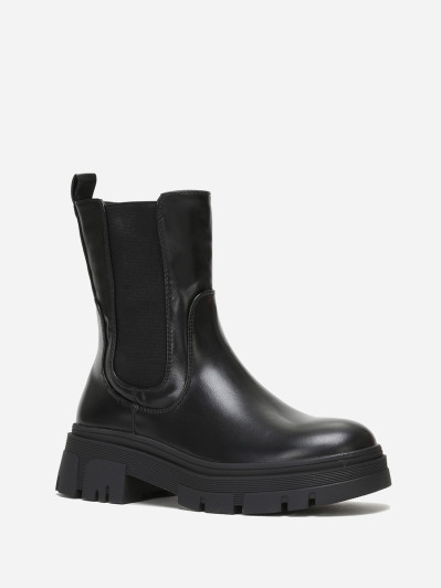 Bottines chelsea crantées en simili noir